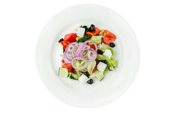 Classic Greek salad in a white plate. Traditional popular mediterranean dish. Top view. Close-up. Isolated on white background.