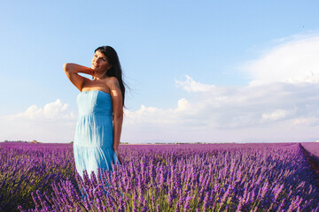 Young woman posing in lavender field on a sunny day, Provence