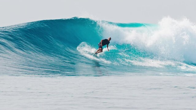 Surfer rides the big wave in the Maldives, Sultans surf spot during big swell day