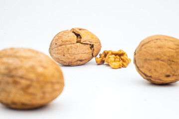 Walnut with leaf isolate. Walnuts peeled and unpeeled with leaves on white. Walnut nut side view. With clipping path..