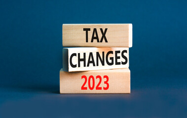 Tax changes 2023 symbol. Concept words Tax changes 2023 on wooden blocks on a beautiful grey table grey background. Business Tax changes 2023 concept. Copy space.