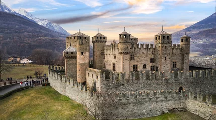 Poster one of the most beautiful and famous medieval castles of Italy Castello di Fenis in Valle d'Aosta , aerial drone view © Freesurf