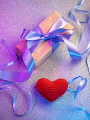 valentine's day gift , gift box with purple ribbon and red heart, bokeh background