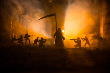 Concept of death soldiers during the war. Grim reaper (Skeleton) holding schyte with military...