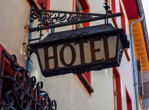 Old hotel sign made of metall on a medieval fascade