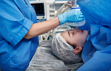 Female patient being sedated by anesthesiologist before surgical procedure. Anesthesia for surgery