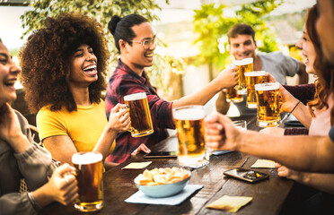 Young people drinking and toasting beer pint at brewery bar restaurant - Beverage life style...