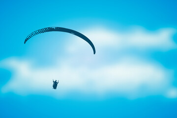 paragliding adventure paraglider in blue cloudy sky