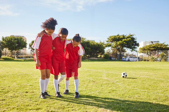 Children, soccer and girl team help, support and walking with injured friend at soccer field. Sports injury, kids and football player group helping, holding and carrying player for football accident