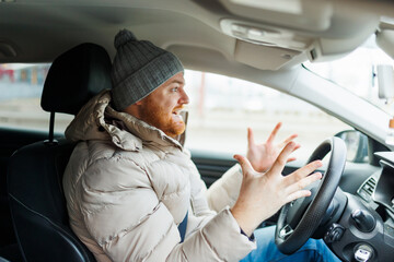 Angry driver in a traffic jam. He screams and gesticulates,