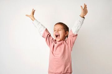Portrait of cheerful girl with raised hands