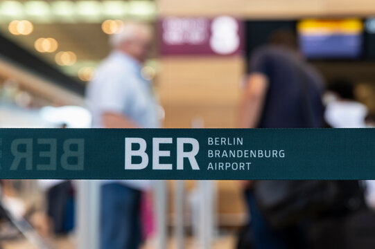 Berlin Brandenburg airport - July 24th, 2022:Close-up BER code Berlin Brandenburg airport logo security barrier tape divider ribbon inside new terminal building. Trade union strike flight cancellation