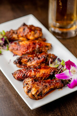 
Chicken wings. Buffalo chicken wings. American cuisine of chicken wings deep-fried, dipped in buffalo sauce made of vinegar,  cayenne hot sauce and butter. Served with celery, carrots, blue cheese.