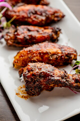 
Chicken wings. Buffalo chicken wings. American cuisine of chicken wings deep-fried, dipped in buffalo sauce made of vinegar,  cayenne hot sauce and butter. Served with celery, carrots, blue cheese.