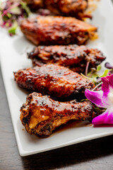 
Chicken wings. Buffalo chicken wings. American cuisine of chicken wings deep-fried, dipped in buffalo sauce made of vinegar,  cayenne hot sauce and butter. Served with celery, carrots, blue cheese.