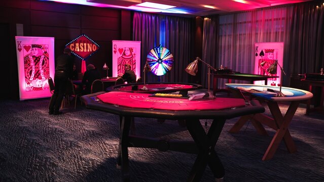 Interior of casino with poker tables and people playing. High quality photo