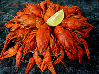 Cooked delicious crayfish with lemon on a dark background background. Seafood. High quality photo