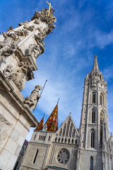 Fototapeta na wymiar Beautiful Matyas templom Matthias church in Buda castle Budapest with blue sky with trinity statue