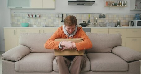 Man blogger holds box and wants to open with anticipation