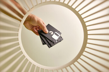 Old FDD diskettes are thrown into the trash for disposal and recycling. View from below. The...