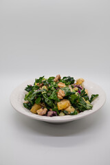 Healthy raw laminate kale salad with walnuts and pear