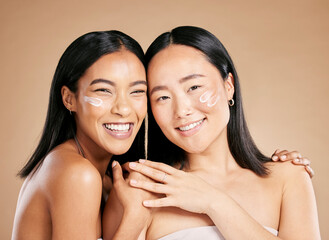 Portrait, cream and diversity with model woman friends in studio on a beige background for skincare. Face, natural and wellness with a young female and friend posing to promote a cosmetic product