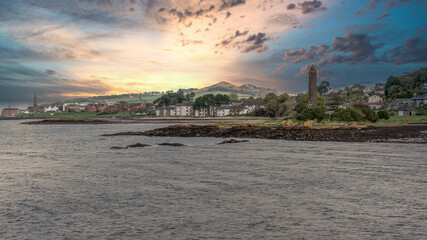Scottish Town of largs Looking North Past the Pencil Monument with the sun going down behind Knock...