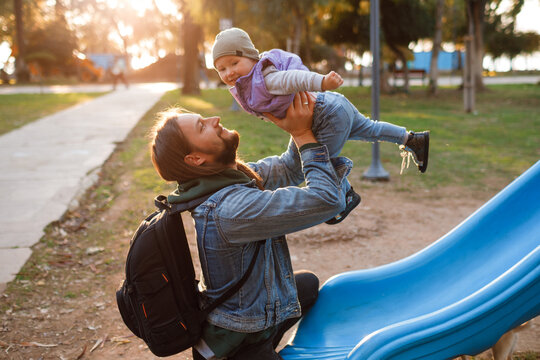 Dad and son swing on a swing. Happy family. The father spends time with the children