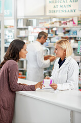 Wellness, health and happy pharmacy customer at store counter for medicine expertise with smile. Pharmaceutical advice and opinion of woman pharmacist helping girl with medication information.