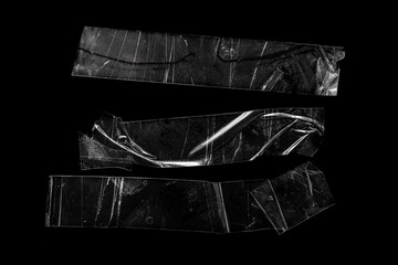 pieces of transparent tape on a black isolated backgroun