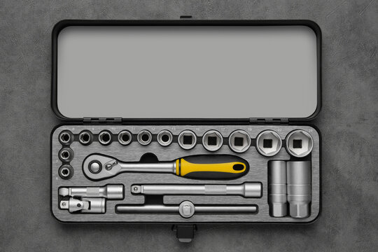 Ratchet and bits tool kit. Socket wrench and ratchet heads. Tool kit for the car. Set of tools for car repair on gray background. Top view, flat lay.