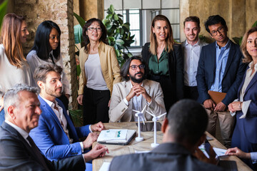 Group of workers gathered to look for alternative energies to fight against global warming. Concept: Business, clean energy, success