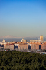 Madrid. Pollution. Contamination. Views of the city of Madrid with a gray and brown layer of pollution beret over the city. Sierra de Guadarrama with snow on the mountain. Photography.