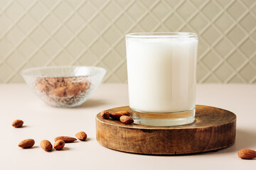 Almond milk in a glass with nuts.