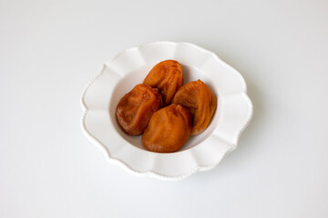 White plate of Dried Persimmon on the white background