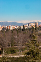 Fototapeta na wymiar Madrid. Pollution. Contamination. Views of the city of Madrid with a gray and brown layer of pollution beret over the city. Sierra de Guadarrama with snow on the mountain. Photography.
