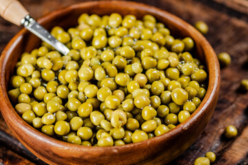 Canned green peas on a cutting board. 