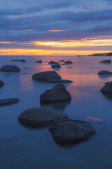 Sunset seascape, Baltic sea shore with boulders, long exposure