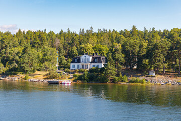 Stockholm Archipelago, view from the cruise ship. Cottages on the shore