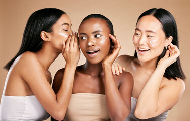 Beauty secret, skincare cream and diversity women friends whisper about inclusion advertising in studio. Asian and black people talk about wow skin glow, spa facial and face with dermatology product - obrazy, fototapety, plakaty