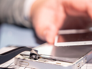 A technician repairs a smartphone in a laboratory with copy space. concept of computer hardware,...