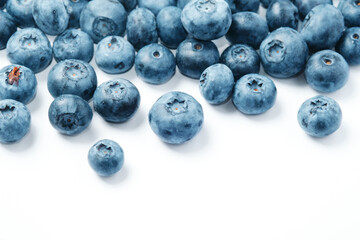 Fresh blueberries scattered on a white background.