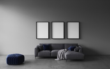 Open space or modern living room with grey sofa, blue velvet pouf, decorative pillows, concrete floor. Empty white frames on wall for art or product presentation, exhibition, mockup frame. 3d renderng