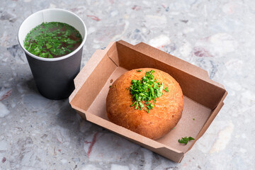 Delicious meat donuts and Broth in a paper cup.
