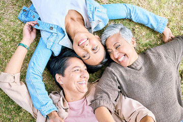 Park, friends relax and top view of women bonding, caring and enjoying quality time together. Peace, freedom and happy group of retired senior females lying on grass talking, chatting and having fun.