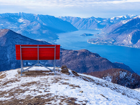 Big red bench on the landscape of Lake Como