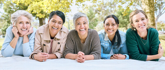Friends, portrait and senior women on picnic at park for bonding, wellness and relaxing on blanket. Happiness, relax or group of elderly retirement people in interracial friendship in nature together