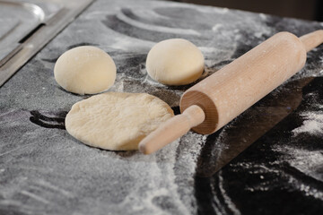 pizzaiolo prepares pizza in the kitchen, the chef prepares the dough