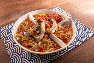 Spicy chilli Mao Xiang Big Fish Head with Fish Pork, Bean Pork with Potato Flour served dish isolated on wooden table top view of Hong Kong food