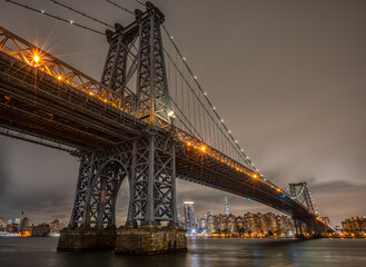 Fototapeta na wymiar View of the Brooklyn, Manhattan and Williamsburg Bridge at night. Long Exposure Photo Shoot.